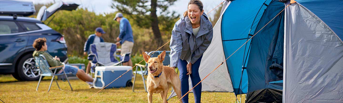 family-camping-with-their-dog