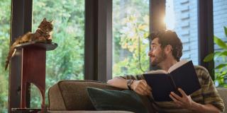 Reading-together-in-sunlight-man-and-his-cat